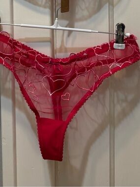 Skims heart embroidered unlined tulle thong. Punch color. NWOT